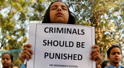 schoolgirls paying homage to rape victim