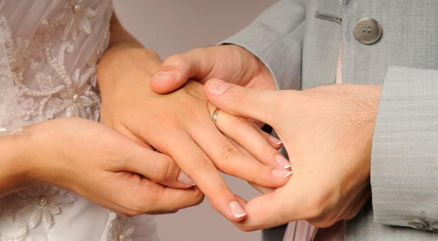 bride and groom exhange rings