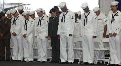 Navy sailors praying