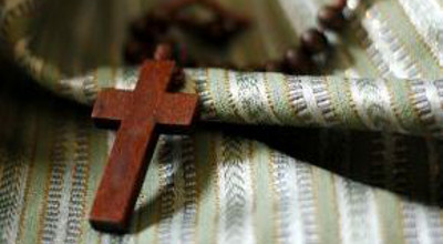 A wooden cross on Syrian fabric