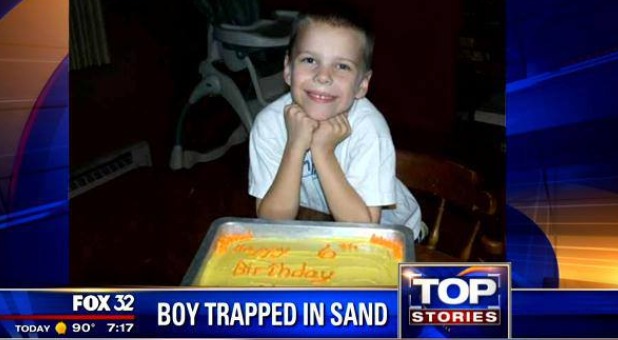 boy trapped in sand