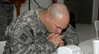 military chaplain prays