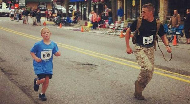 photo of Marine running alongside young boy
