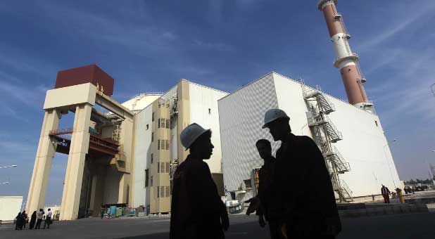 Iranian workers stand in front of the Bushehr nuclear power plant, about 1,200 km (746 miles) south of Tehran.