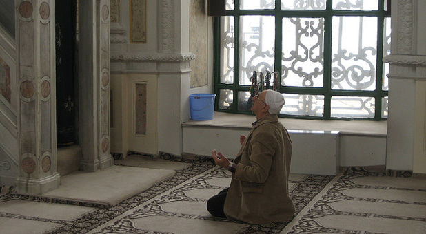 Muslim man praying at mosque