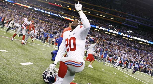 New York Giants cornerback Prince Amukamara points to heaven in praise after the Giants won the 2011 Super Bowl against the New England Patriots.