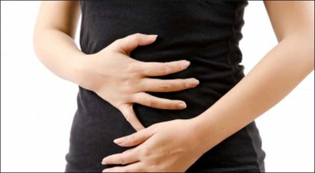 Woman holds stomach