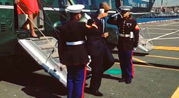 Barack Obama saluting Marines with coffee cup