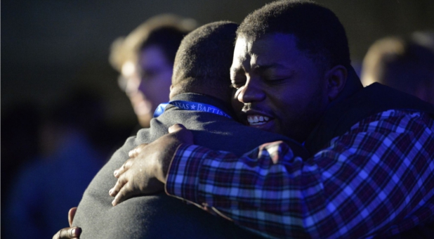 2 men at a conference hugging