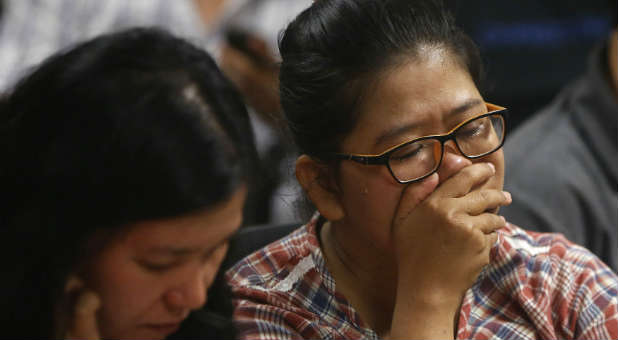 Family members of the missing Air Asia flight.