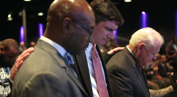 Billy Graham's grandson Will, center, praying