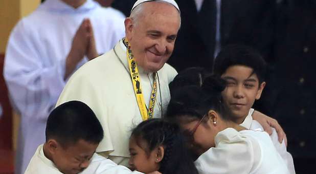 The Pope hugs children during his tour of the Philippines.