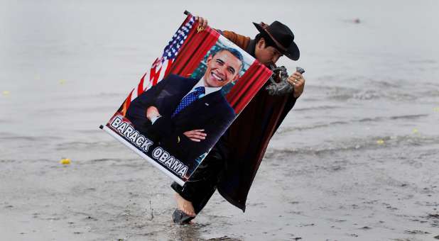 A Cuban shaman performs a ritual with Barack Obama's picture.