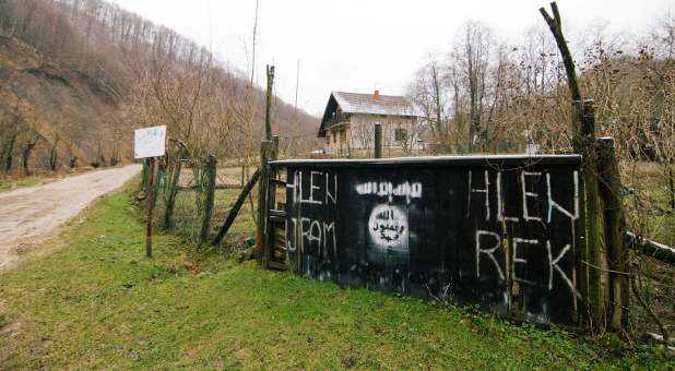 An entrance to the Bosnian village of Gornja Maoca decorated with Islamic State sign.