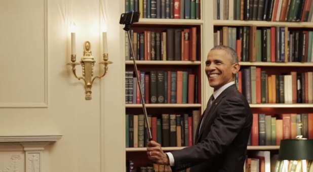 U.S. President Barack Obama taking a selfie with a selfie stick.