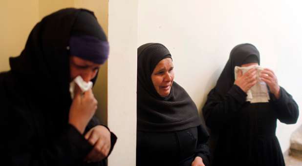 Relatives of Egyptian Coptic men killed in Libya mourn at their house in El-Our village.