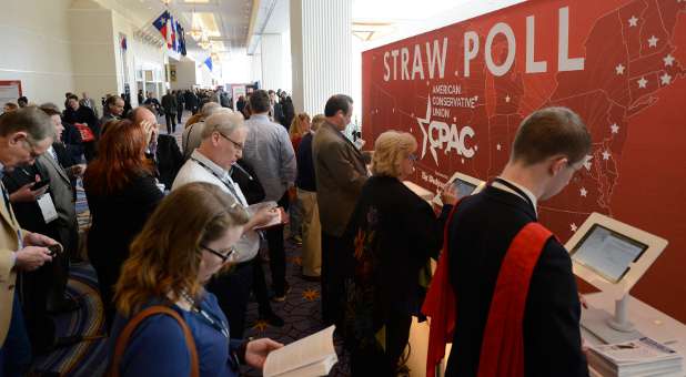 Guests queue to place their votes in an electronic straw poll for possible presidential candidates at the Conservative Political Action Conference.