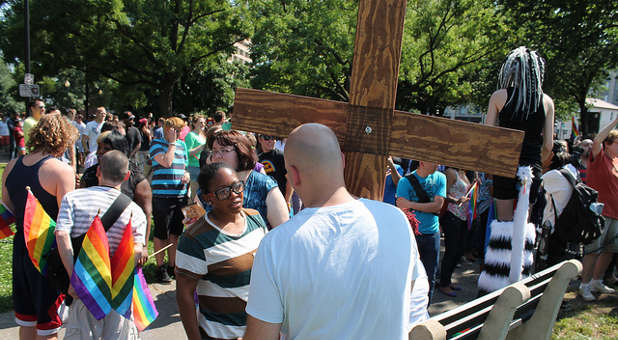 A street preacher at a gay pride parade.