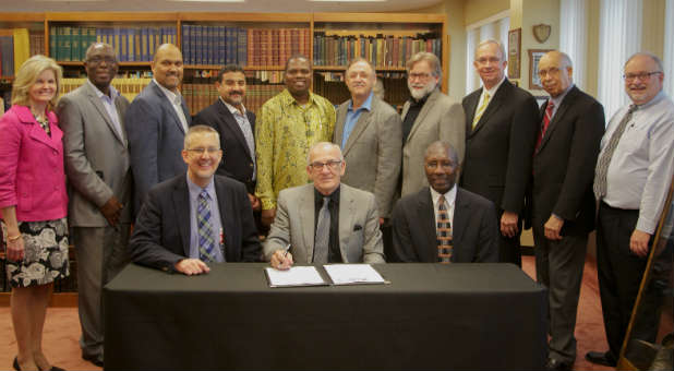 Leaders of the Church of God of Prophecy sign a partnership with Multiplication Network Ministries.
