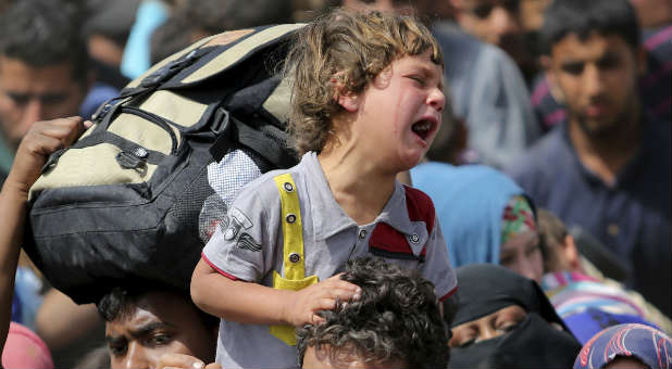 A child sobs as his family flees Islamic State militants.