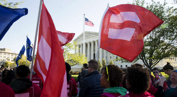 Gay marriage supporters rally outside the Supreme Court.