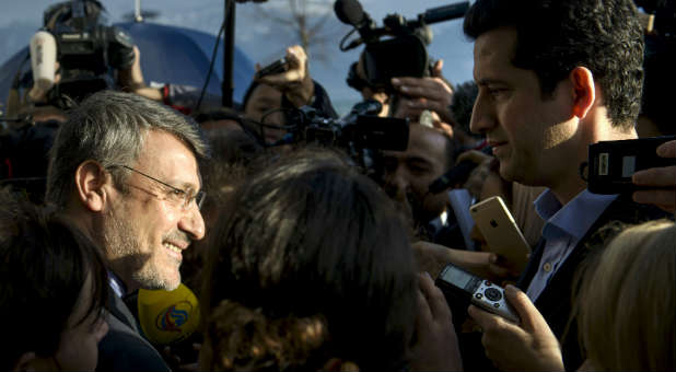 Hamid Baeedinejad (L), an Iranian official, speaks with the press about negotiations on Iran's nuclear program.