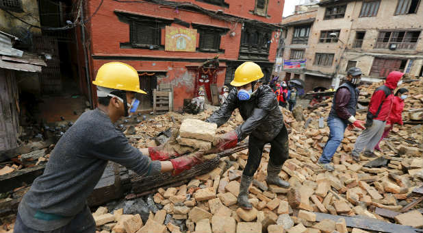 Volunteers work to remove rubble from the Nepal earthquake.