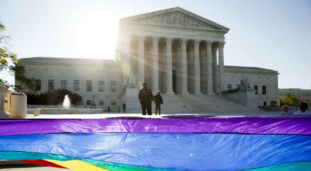 Gay marriage supporters rally outside the Supreme Court.