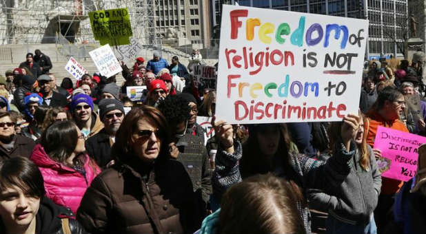 Demonstrators gather to protest Indiana's Religious Freedom Restoration Act.