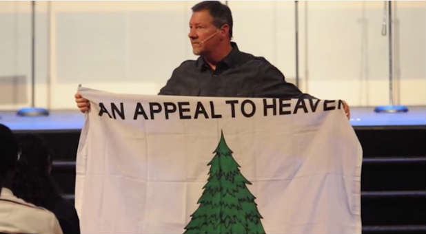 Dutch Sheets holds the Appeal to Heaven flag.