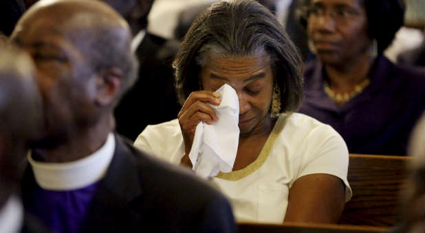 A woman mourns at the memorial service for those killed in the attack on Emanuel AME church in Charleston.