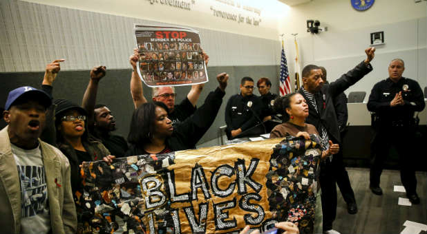 Protestors hold up 'Black lives matter' banners.