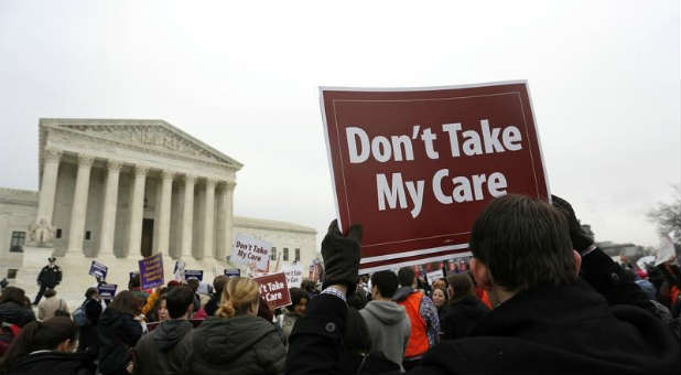 Demonstrators gather outside the Supreme Court during the Obamacare ruling.