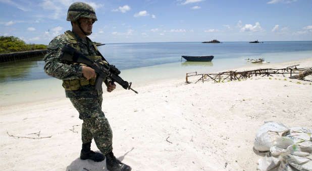 A soldier on the beach in the South China Sea