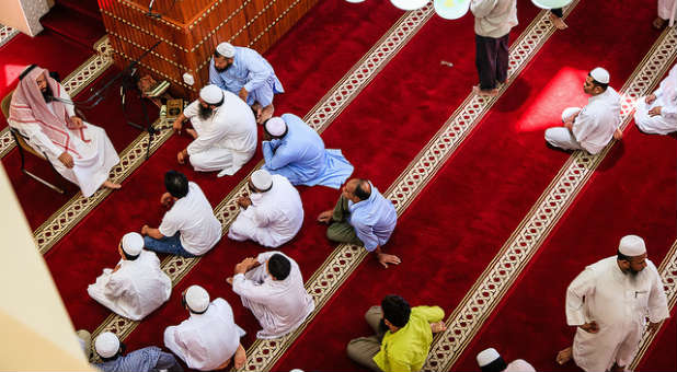 Muslim men in a service at a mosque.