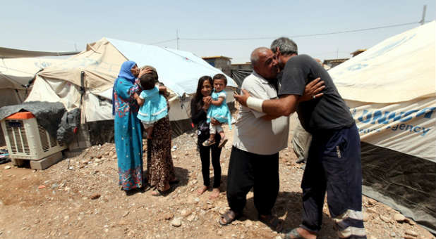 Displaced Iraqis greet relatives.
