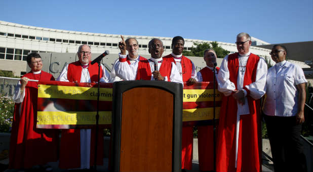 Episcopal bishops show their support for Bishop-Elect Michael Curry, center.