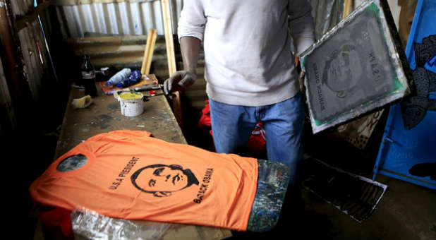 A Kenyan man makes a T-shirt of President Obama in preparation for his visit.
