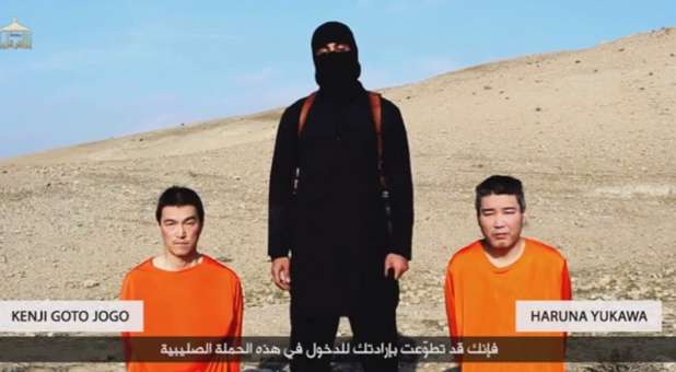 A member of the Islamic State prepares to behead two Japanese hostages.