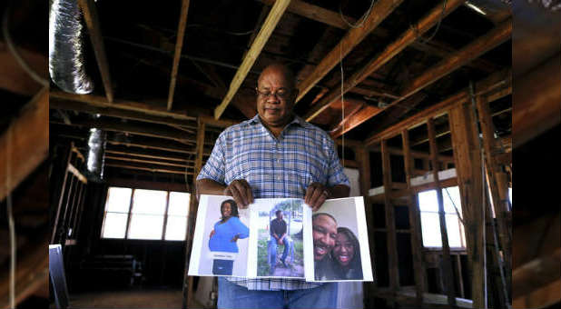 Charles Brown stands in a house still being repaired after Hurricane Katrina.