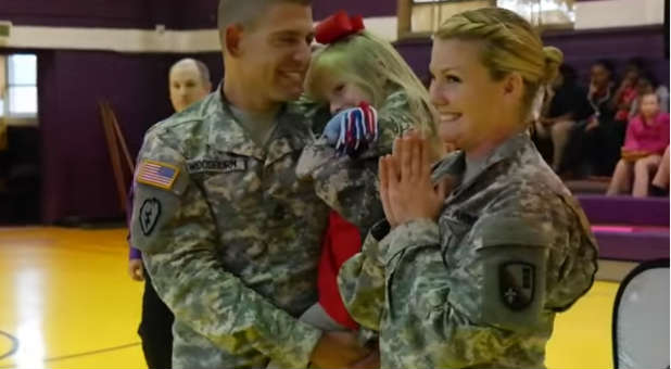 Soldier parents surprise daughter.