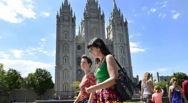 Kate Kelly, foreground, marches past the Salt Lake LDS temple along with others on their way to deliver resignation letters to the Church office building. Prominent dissident Mormons held a rally and mass resignation from the LDS Church