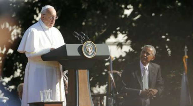 Barack Obama at the left hand of Pope Francis.