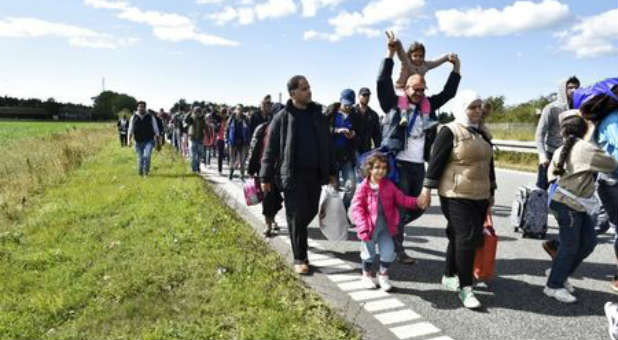 Migrants, mostly from Syria, travel on foot in Europe.