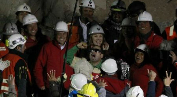 Miner Mario Sepulveda (C) celebrates as President Sebastian Pinera, rescue workers and government officials watch, when he became the second miner to be hoisted to the surface in Copiapo Oct. 13, 2010.