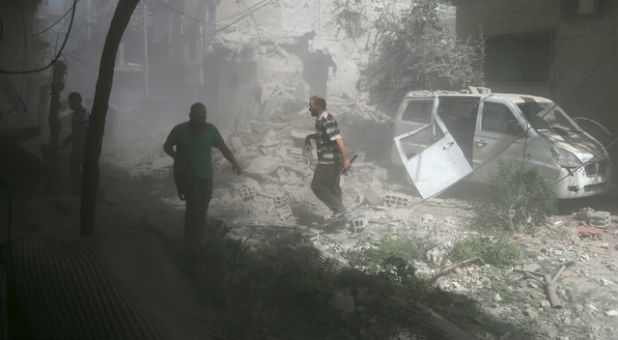 Residents inspect damage from what activists said was an airstrike by forces loyal to Syrian President Bashar al-Assad on the town of Douma, eastern Ghouta in Damascus.