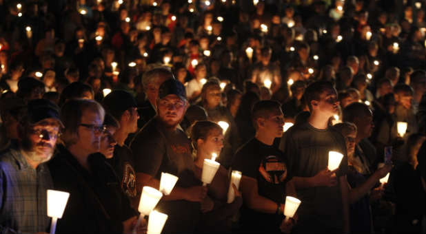 Hundreds gather for a candlelight vigil for the UCC shooting victims.