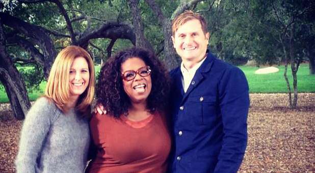 Rob Bell with his wife Kristin talking to Oprah Winfrey.