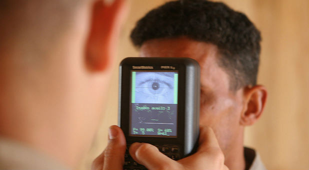 A soldier undergoes a biometric scanning process.