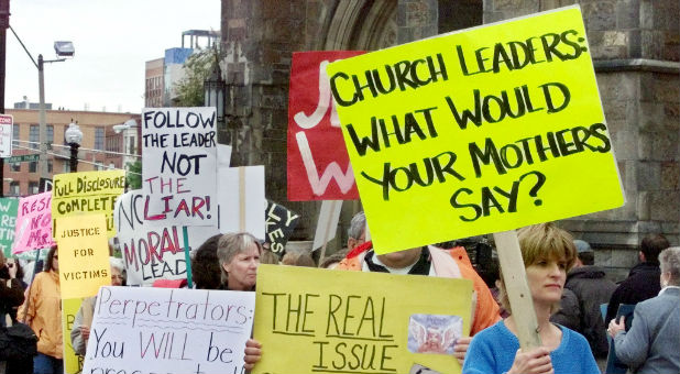 Men and women protest the Catholic Church.